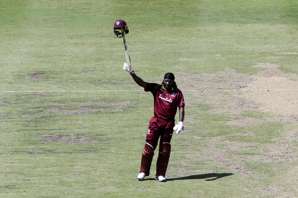 West Indies' Chris Gayle celebrates after he scored a century against England during the first One Day International cricket match at the Kensington Oval in Bridgetown, Barbados, Wednesday, Feb. 20, 2019. (AP Photo/Ricardo Mazalan)