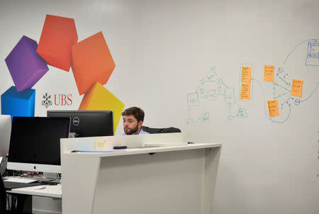 A UBS employee works in the UBS "fintech lab" at Canary Wharf in London, Britain, October 19, 2016. REUTERS/Hannah McKay