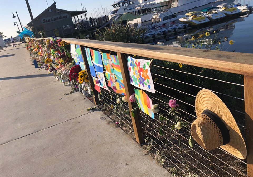 A growing memorial to those who died aboard the dive boat Conception is seen early Friday morning, Sept. 6, 2019 at the harbor in Santa Barbara, Calif. The Sept. 2 fire took the lives of 34 people on the ship off Santa Cruz Island off the Southern California coast near Santa Barbara (AP Photo/Stefanie Dazio)