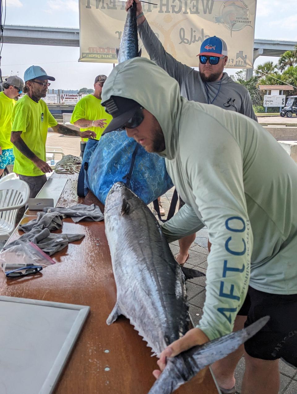 Travis Crowley and Lucas Crowley unload their winning catch at the Greater Jacksonville Kingfish Tournament on Friday.