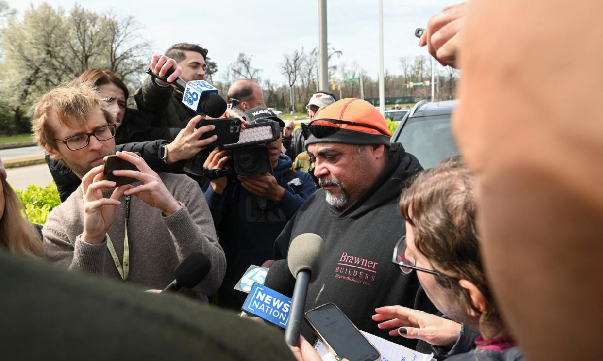 <span>Jesús Campos, a worker originally from El Salvador, speaks about the men who were working on the night shift on the bridge.</span><span>Photograph: Roberto Schmidt/AFP/Getty Images</span>