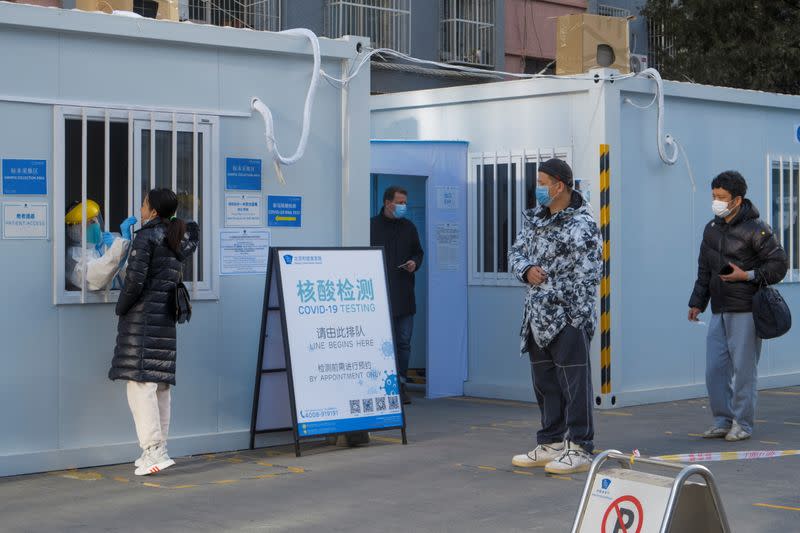 People line up to get their nucleic acid test in the courtyard of a hospital following the outbreak of the coronavirus disease (COVID-19) in Beijing