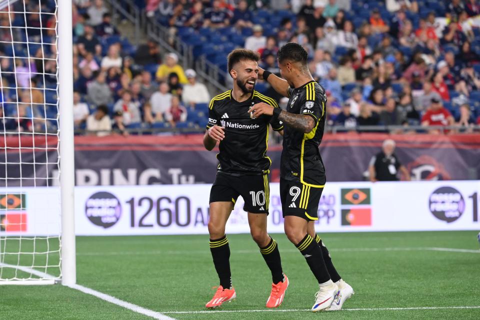 Crew forward Diego Rossi (10) celebrates with teammate Cucho Hernandez (9) after scoring a goal in Saturday's 5-1 win over New England.