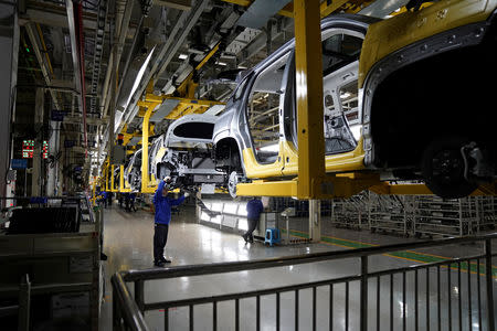 Employees work on Baojun RS-5 cars at a final assembly plant operated by General Motors Co and its local joint-venture partners in Liuzhou, Guangxi Zhuang Autonomous Region, China, February 28, 2019. REUTERS/Aly Song