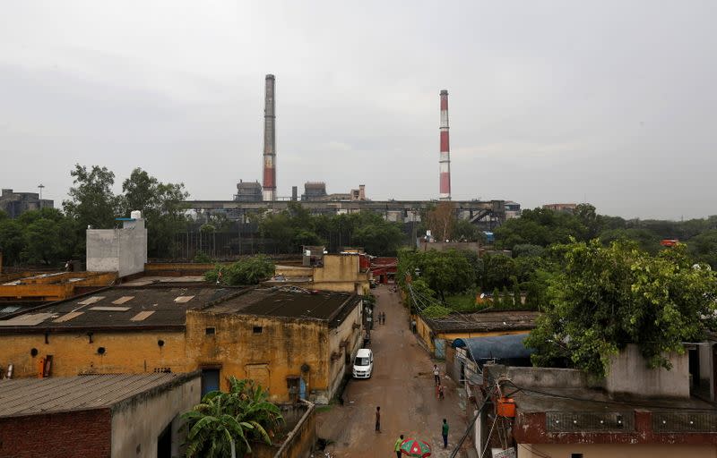 FILE PHOTO: Chimneys of a coal-fired power plant are pictured in New Delhi