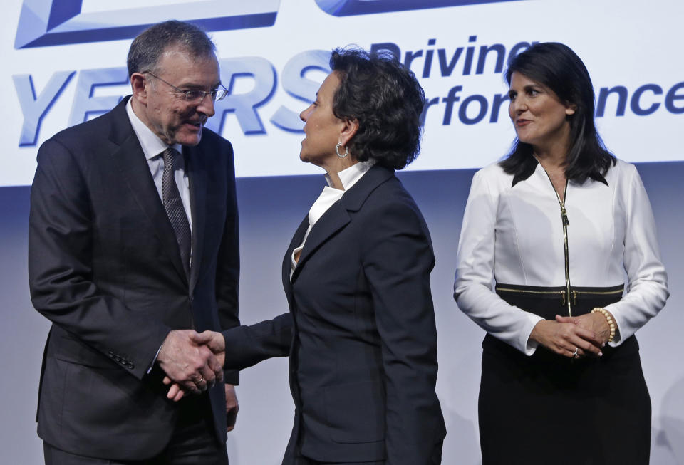 U.S. Secretary of Commerce, Penny Pritzker, center, shakes hands with Dr. Norbert Reithofer, Chairman of the Board of Management, BMW Group, left, as South Carolina Gov. Nikki Haley, right, watches after a news conference at the BMW manufacturing plant in Greer, S.C., Friday, March 28, 2014. The company announced a $1 billion expansion for the plant. (AP Photo/Chuck Burton)