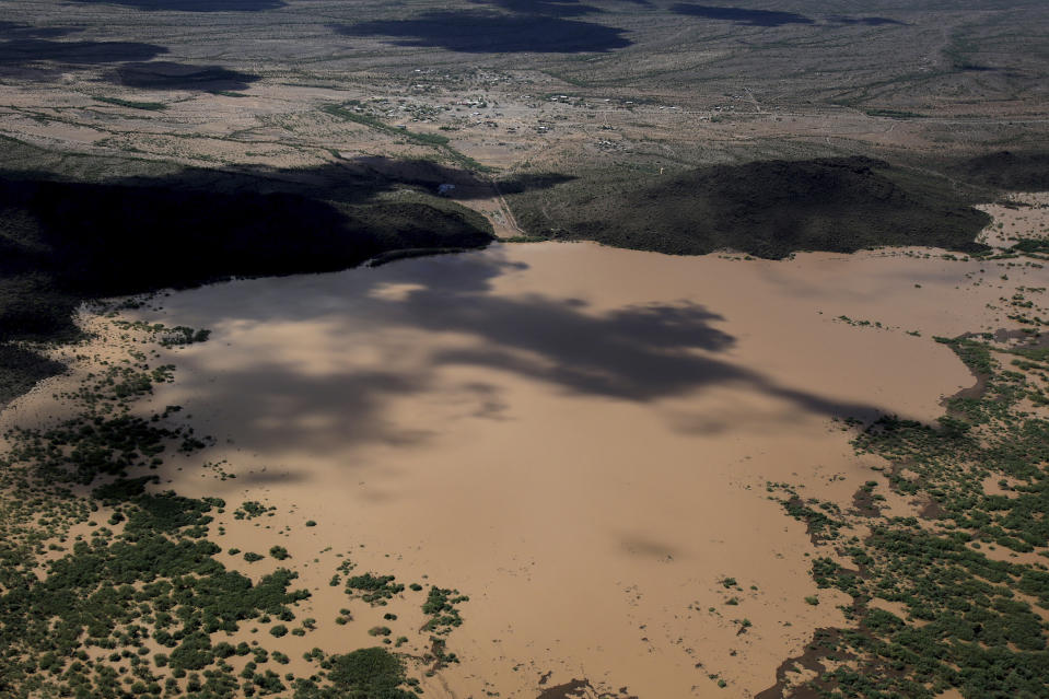 The earthen Menagers Dam that was in imminent danger of failing, potentially sending floodwaters rushing into the Tohono O'odham village of Ali Chuk, has held steady as the lake behind it receded on Wednesday, Oct. 3, 2018, southwest of Sells, Ariz. Evacuations had begun Tuesday night after Hurricane Rosa's remnants drenched the western half of Arizona. (Mike Christy/Arizona Daily Star via AP)