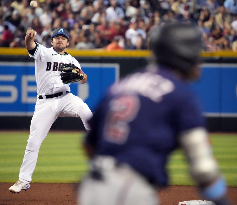 Jun 19, 2022; Phoenix, Arizona, USA; Arizona Diamondbacks second baseman Buddy Lewis Kennedy (45) is unable to force out Minnesota Twins second baseman Luis Arraez (2) at first base during the third inning at Chase Field.