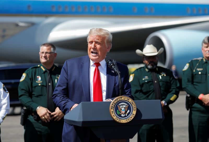 U.S. President Donald Trump speaks to supporters as he arrives in Tampa, Florida