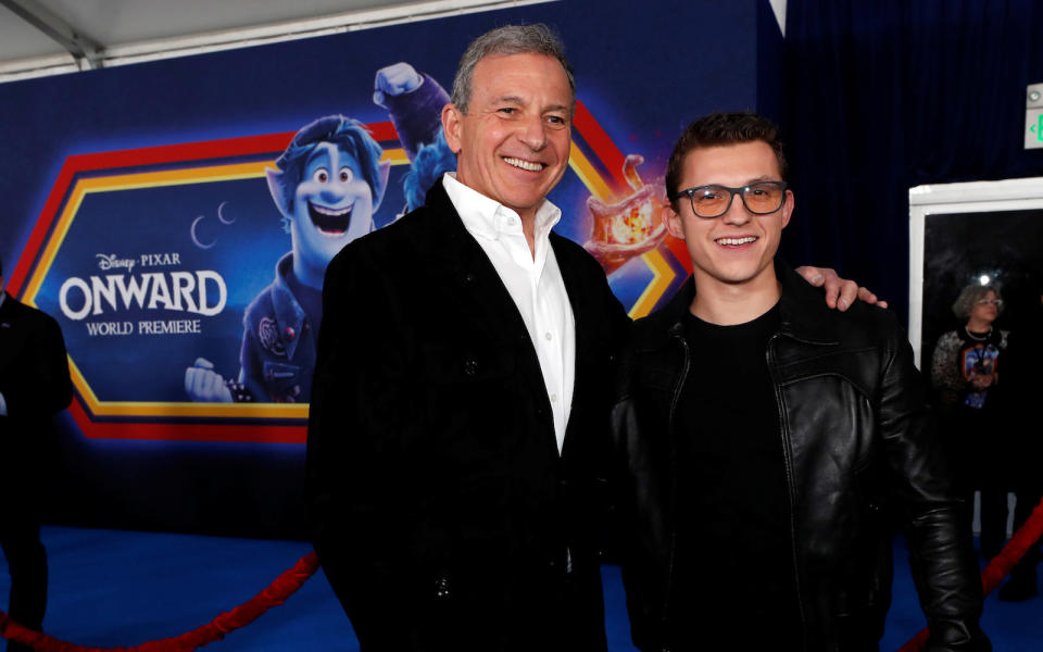 Cast member Tom Holland and Bob Iger, CEO of the Walt Disney Company, pose at the premiere for the film 