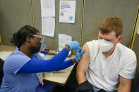 FILE - A registered nurse gives James Mullen the second dose of the coronavirus vaccine at a COVID-19 vaccination site at NYC Health + Hospitals Metropolitan, Thursday, Feb. 18, 2021, in New York. After months of coaxing people to get vaccinated against COVID-19 with incentives like museum tickets and transit passes, New York City is sweetening the pot by offering $100 to any city resident who gets a first dose of a coronavirus vaccine at a city-run site, Mayor Bill de Blasio said Wednesday, July 28, 2021. (AP Photo/Mary Altaffer, File)