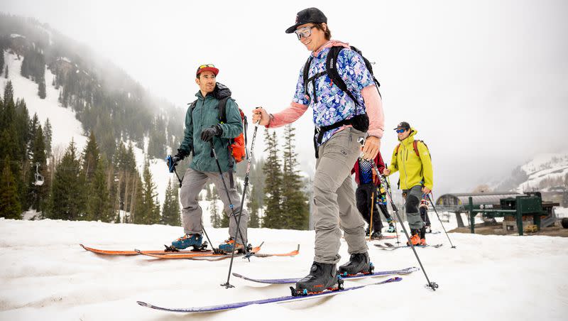 Parker Densmore, center, and friends start a backcountry ski tour at Alta Ski Area, which is closed for the season, on Friday, June 2, 2023. The group was celebrating Densmore’s 200th consecutive day of skiing this season.