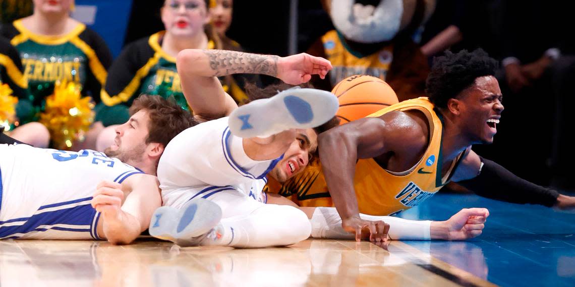 Duke’s Ryan Young (15) and Tyrese Proctor (5) dive after a loose ball with Vermont’s Sam Alamutu (2) during the second half of Duke’s 64-47 victory over Vermont in the first round of the NCAA Tournament at the Barclays Center in Brooklyn, N.Y., Friday, March 22, 2024. Ethan Hyman/ehyman@newsobserver.com