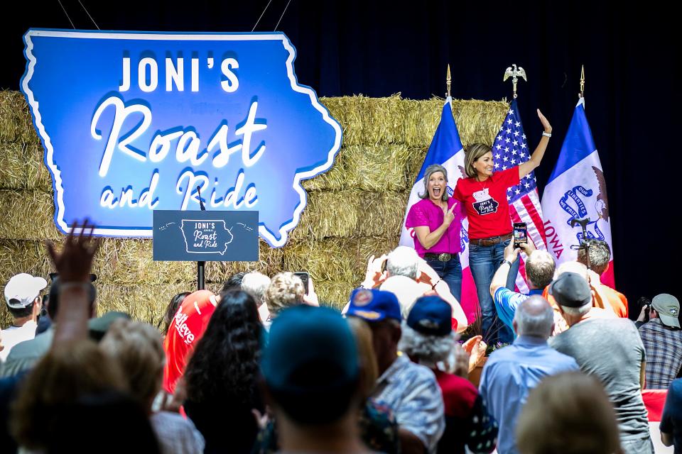 U.S. Sen. Joni Ernst, left, greets Iowa Gov. Kim Reynolds during the annual Roast and Ride fundraiser, Saturday, June 3, 2023, at the Iowa State Fairgrounds in Des Moines, Iowa.