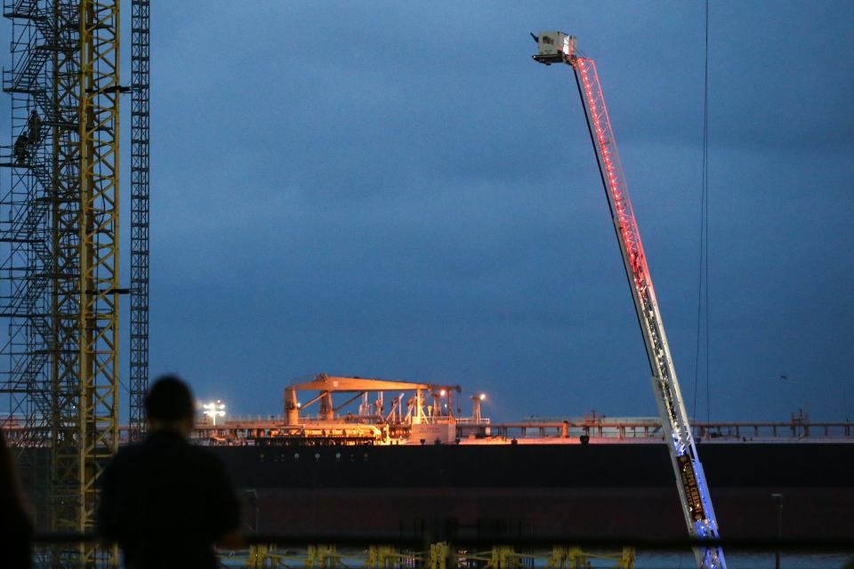 Firefighters descend a crane that caught fire while working the new Harbor Bridge project on Saturday, April 22, 2023, in Corpus Christi, Texas.
