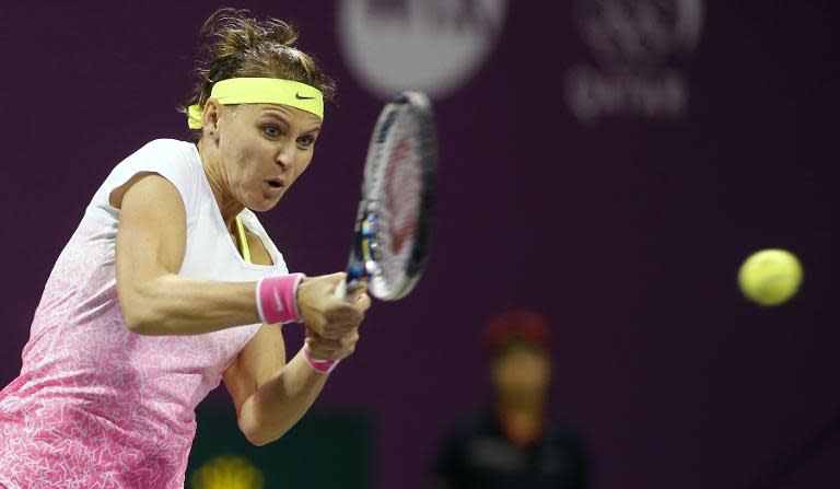 Lucie Safarova of the Czech Republic returns the ball to Carla Suarez Navarro of Spain during their WTA Qatar Open semi-final tennis match on February 27, 2015 in Doha