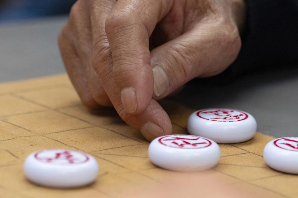 A man plays Xiangqi, or Chinese chess, in a public park in Chinatown near a remembrance ceremony for Vincent Chin, Sunday, June 23, 2024, in Boston. Over the weekend, vigils were held across the country to honor the memory of Chin, who was killed byy two white men in 1982 in Detroit. (AP Photo/Michael Dwyer)