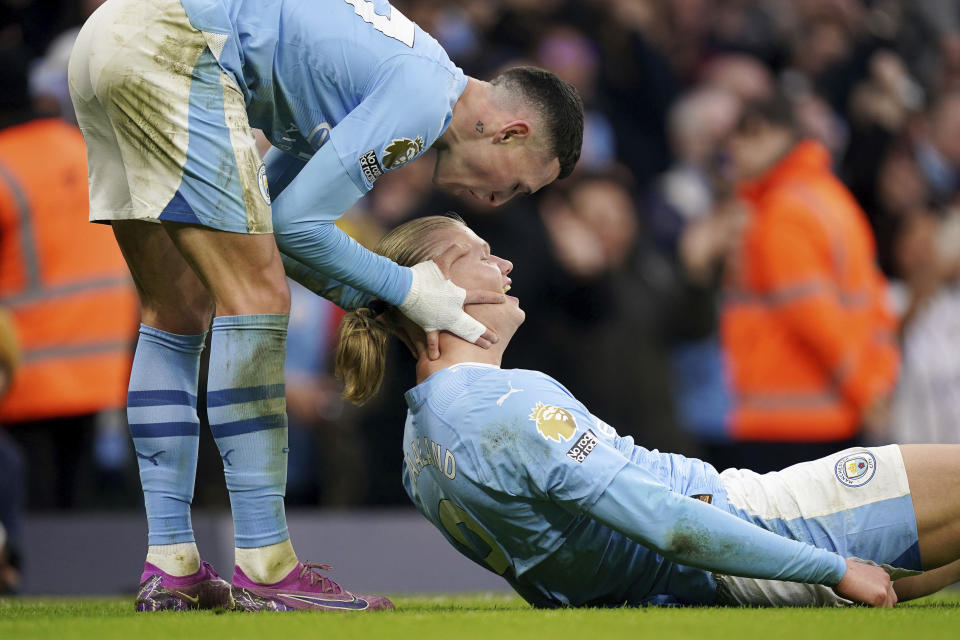 Manchester City's Erling Haaland, right, celebrates with teammate Phil Foden, after scoring his side's third goal during the English Premier League soccer match between Manchester City and Manchester United, at the Etihad Stadium in Manchester, England, Sunday, March 3, 2024. (Mike Egerton/PA via AP)