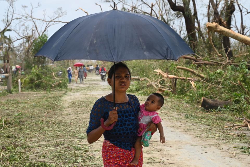 A woman carries her baby as she walks in Sittwe, Myanmar, on Monday.