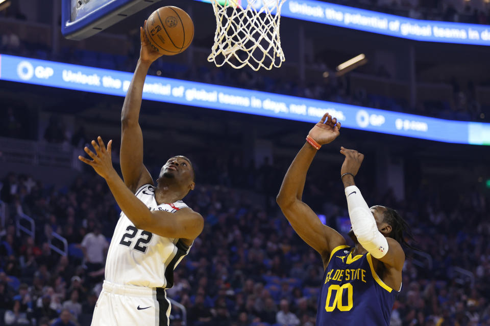 San Antonio Spurs guard Malaki Branham (22) shoots against Golden State Warriors forward Jonathan Kuminga (00) during the first half of an NBA basketball game in San Francisco, Friday, March 31, 2023. (AP Photo/Jed Jacobsohn)