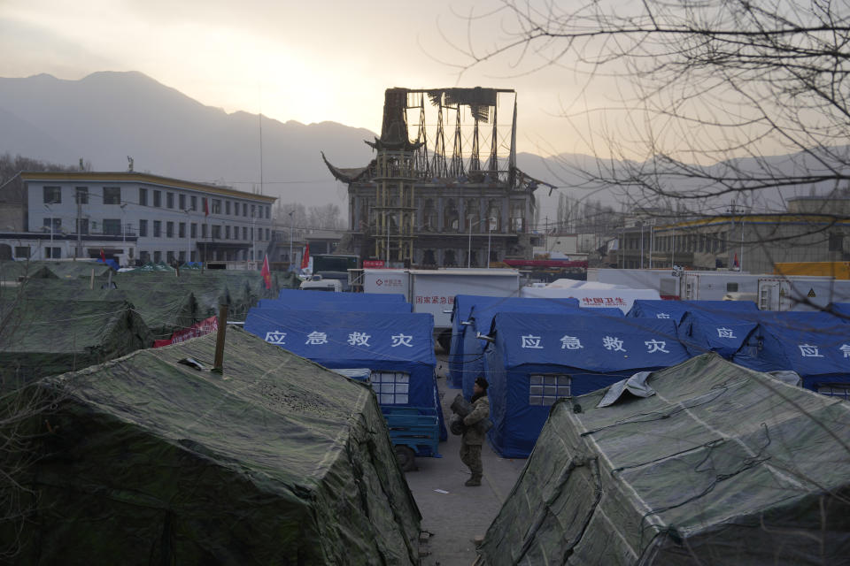 A soldier walks past tents at a temporary shelter for residents after an earthquake in Dahejia town in northwestern China's Gansu province, Wednesday, Dec. 20, 2023. A strong overnight earthquake rattled a mountainous region of northwestern China, authorities said Tuesday, destroying homes, leaving residents out in a below-freezing winter night and killing many in the nation's deadliest quake in nine years. (AP Photo/Ng Han Guan)