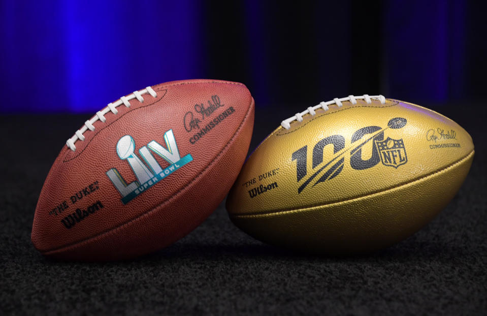 Feb 4, 2019; Atlanta, GA, USA; Detailed view of NFL Wilson gold football to commemorate the league's 100th anniversary and Super Bowl LIV football during the 2019 season at Super Bowl LIII handoff ceremony at Georgia World Congress Center. Super Bowl 54 will be playedi n at Hard Rock Stadium in Miami Gardens, Fla, on Feb. 2, 2020. Mandatory Credit: Kirby Lee-USA TODAY Sports