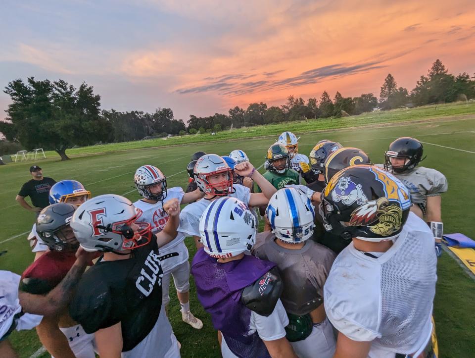 Members of Team North Division II-III squad put their hands together concluding practice at Shasta College before the 46th Lions All-Star game on Tuesday, June 13, 2023.