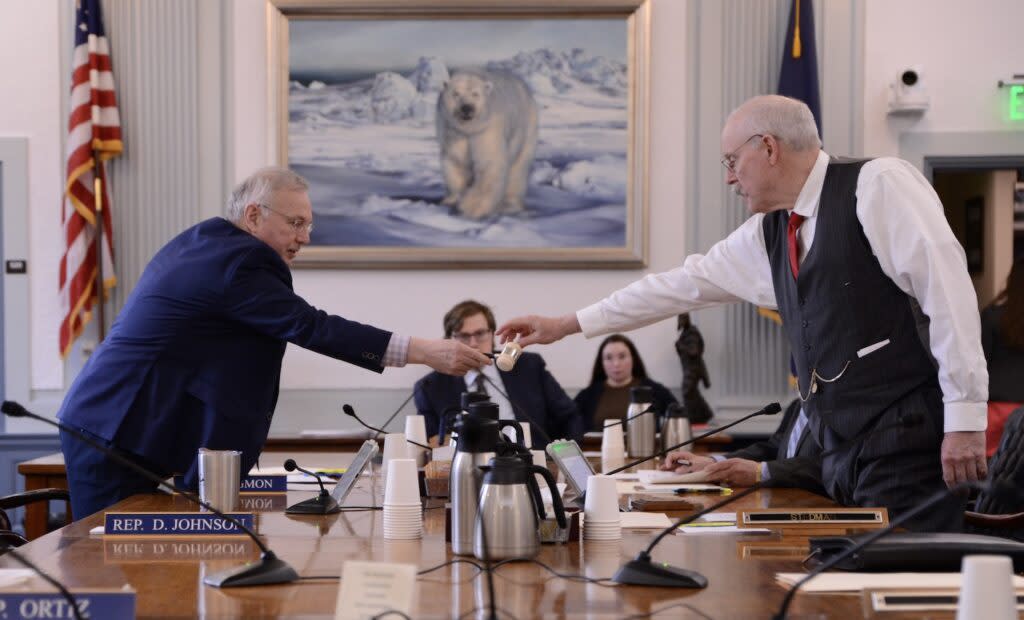 Rep. Bryce Edgmon, I-Dillingham, passes the conference committee gavel to Sen. Bert Stedman, R-Sitka, after examining it Monday, May 13, 2024. (Photo by James Brooks/Alaska Beacon)