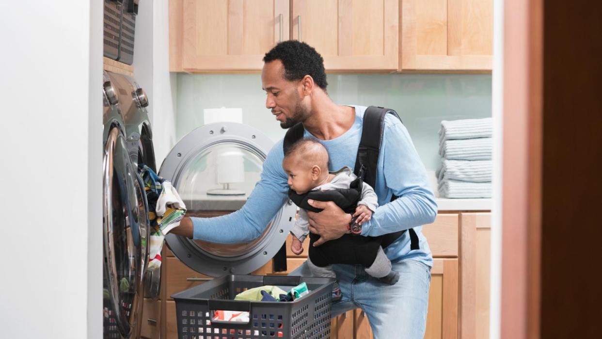 A father with son doing laundry