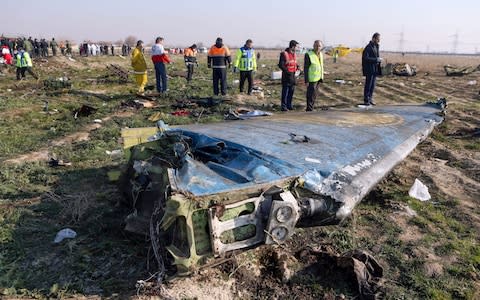 Rescue teams working at the scene of a Ukrainian airliner that crashed shortly after take-off near Imam Khomeini airport - Credit: AFP