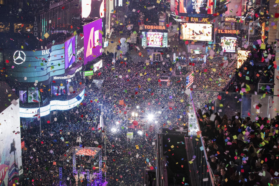 FILE - In this Jan. 1, 2017 file photo, revelers celebrate the new year as confetti flies over New York's Times Square. Year after year, people watching New York City's New Year's Eve celebration are told by city dignitaries and TV personalities that they are watching a million people gathered in Times Square. The AP asks experts whether it is actually possible to fit that many people into the viewing areas. (AP Photo/Mary Altaffer, File)