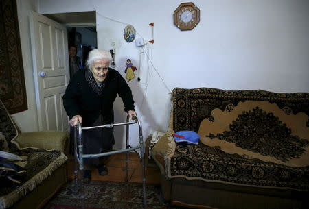 Silvard Atajyan, 103, walks at home during an interview with Reuters in Yerevan, April 20, 2015. REUTERS/David Mdzinarishvili