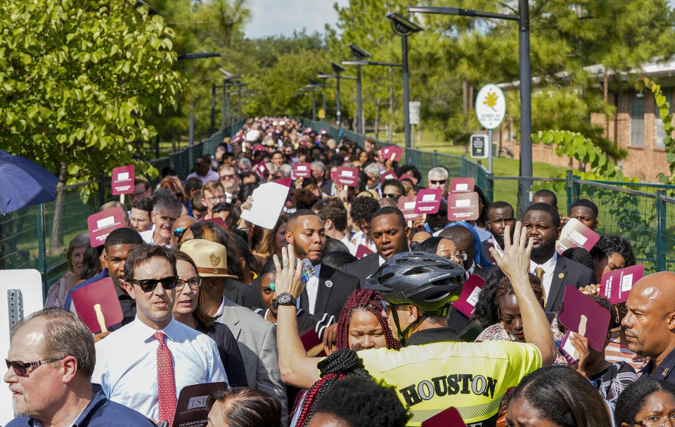 People wait to go through security before entering the Democratic presidential debate inside Texas Southern University's Health & PE Arena in Houston, Thursday, Sept. 12, 2019. Progressive Democrats Elizabeth Warren and Bernie Sanders share the debate stage for the first time with establishment favorite Joe Biden Thursday night in a prime-time showdown displaying sharply opposing notions of electability in the party's presidential nomination fight.(Elizabeth Conley/Houston Chronicle via AP)