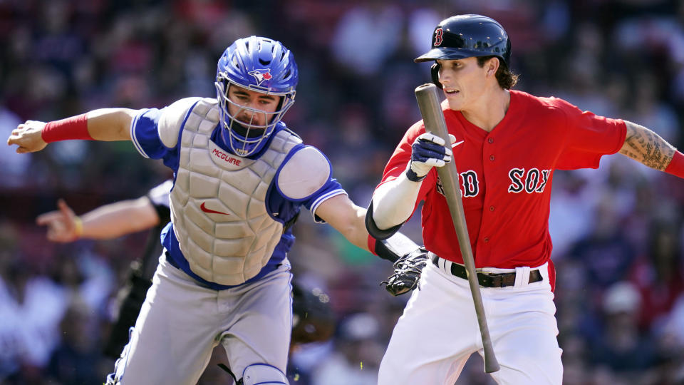 Toronto Blue Jays catcher Reese McGuire, left, tags out Boston Red Sox pinch-hitter Jarren Duran, right, on a strikeout during the seventh inning of a baseball game at Fenway Park, Wednesday, July 28, 2021, in Boston. (AP Photo/Charles Krupa)