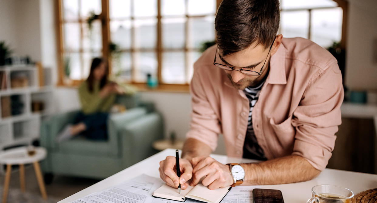 Financial infidelity: Man hiding finances. (Getty Images)