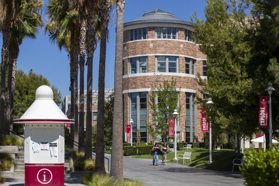 Pedestrians walk around Chapman University in Orange.