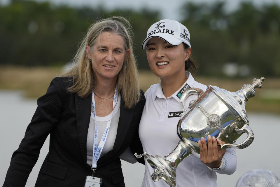 Jin Young Ko, of Korea, right, holds the player of the year trophy along with LPGA Commissioner, Mollie Marcoux, left, after winning the LPGA Tour Championship golf tournament, Sunday, Nov. 21, 2021, in Naples, Fla. (AP Photo/Rebecca Blackwell)