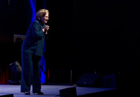 Former U.S. Secretary of State Hillary Clinton looks towards the audience, after someone threw an object onstage, during her speech to members of the Institute of Scrap Recycling Industries in Las Vegas, Nevada April 10, 2014. REUTERS/Las Vegas Sun/Steve Marcus