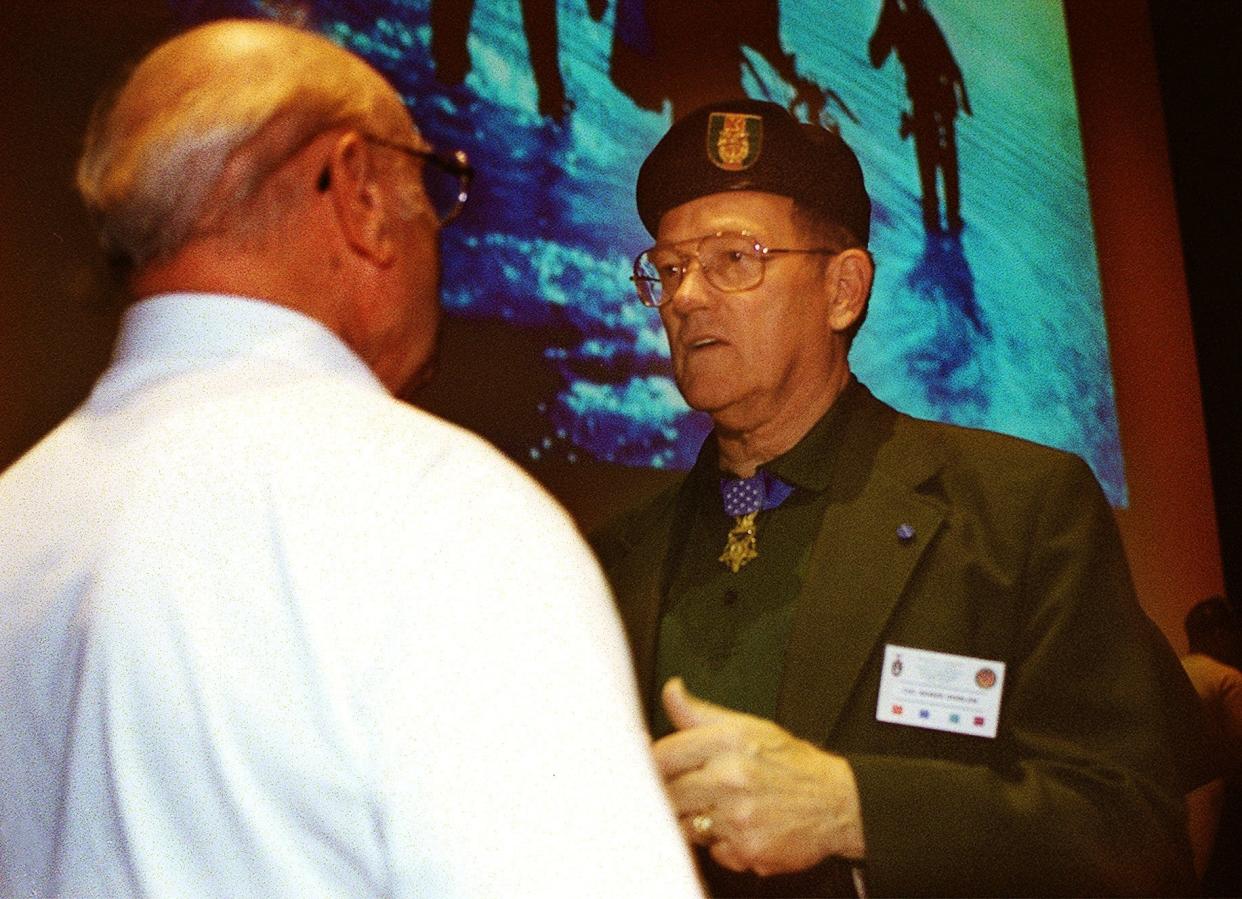 Retired Special Forces Col. Roger H.C. Donlon, left, anwsers questions after speaking at the Special Forces Veterans Forum at the Airborne and Special Operations Museum in 2002. Donlon, a Fort Bragg soldier that was assigned to the 7th Special Forces Group, was the first soldier awarded the Medal of Honor for valorous actions in Vietnam.