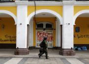 Police officers walk in front of the governorate building in Cochabamba