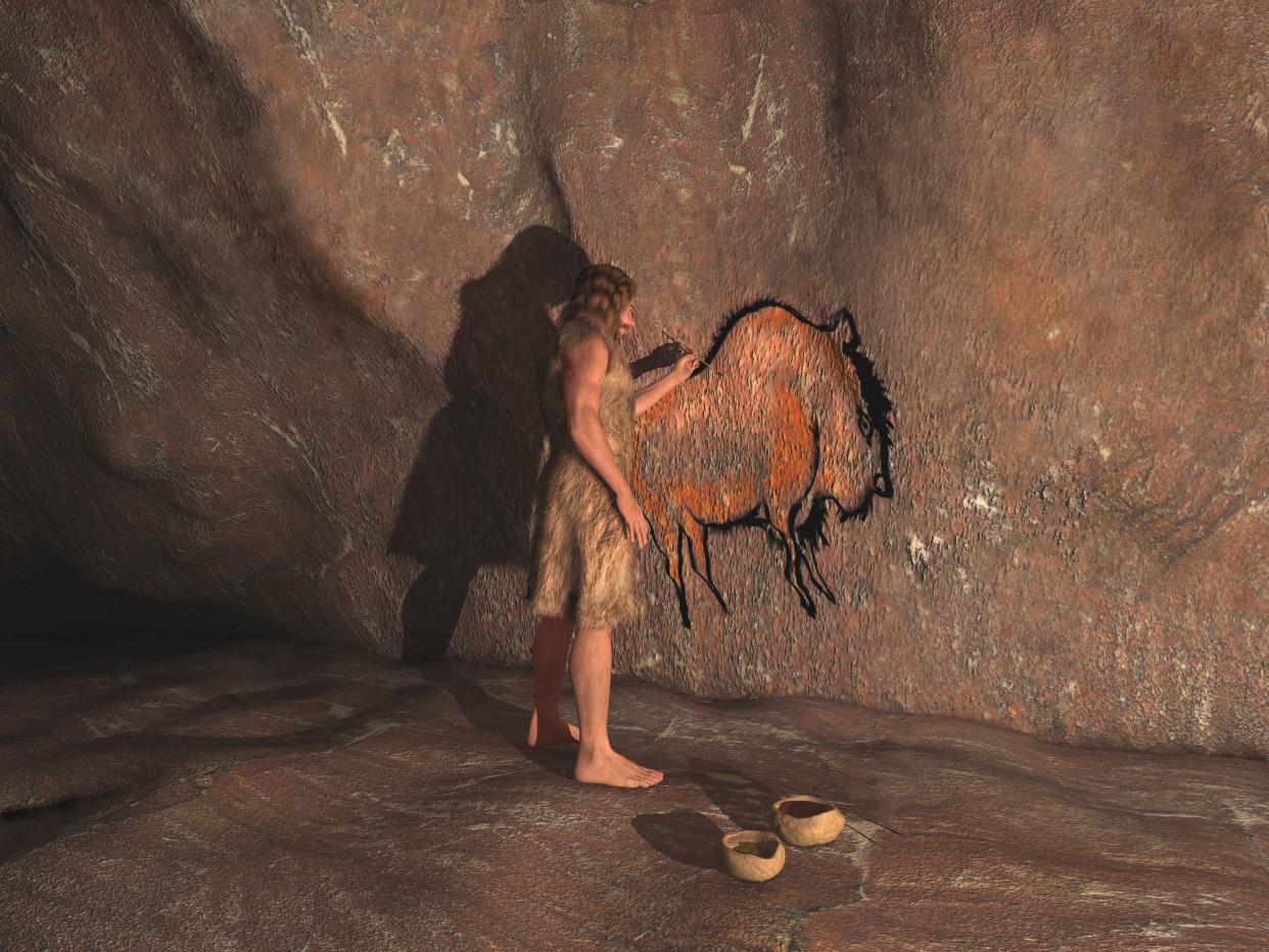 A Neanderthal man painting with his left hand, a bison, in a cave with two clay bowls near, light coming from the right side, with shadowing on the left side