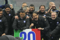 Inter Milan's head coach Simone Inzaghi, center, right, celebrates with his teammate at the end of the Serie A soccer match between AC Milan and Inter Milan at the San Siro stadium in Milan, Italy, Monday, April 22, 2024. (AP Photo/Luca Bruno)