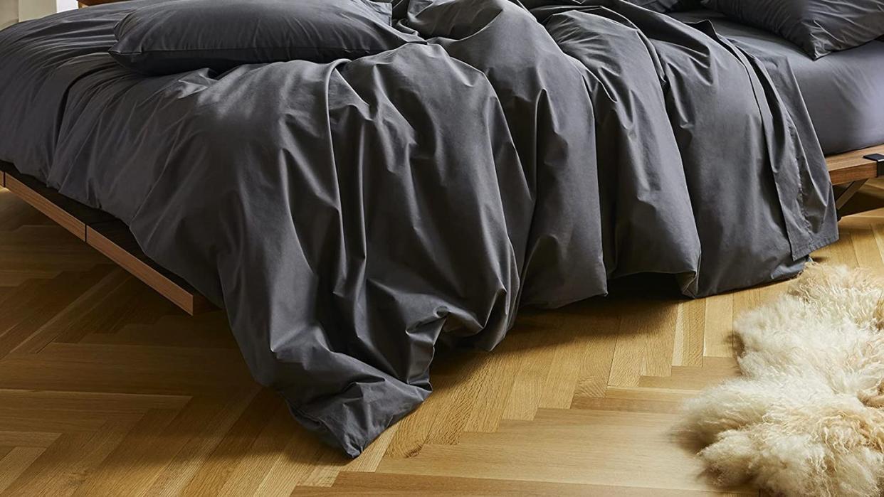 a black bed with a black sheet