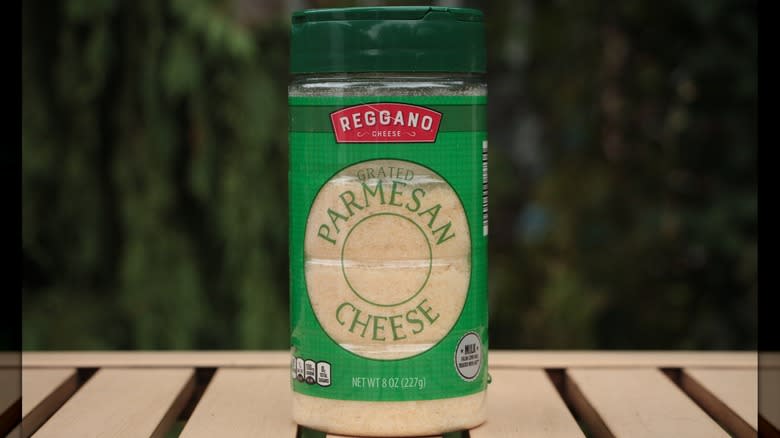 Plastic jar of grated parmesan cheese