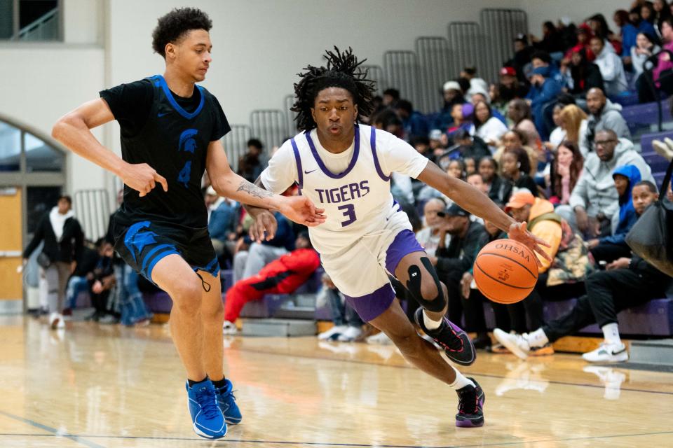 Richmond Heights' Hosea Steele Jr. defends Pickerington Central's Amare Spiva during their game Dec. 17 at Capital.