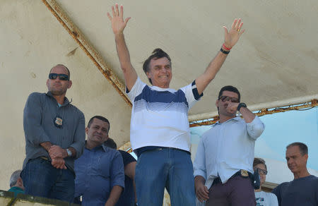 Brazil's new president-elect, Jair Bolsonaro, waves to supporters as he watches airplanes performing near his condominium at Barra da Tijuca neighbourhood in Rio de Janeiro, Brazil October 31, 2018. REUTERS/Lucas Landau