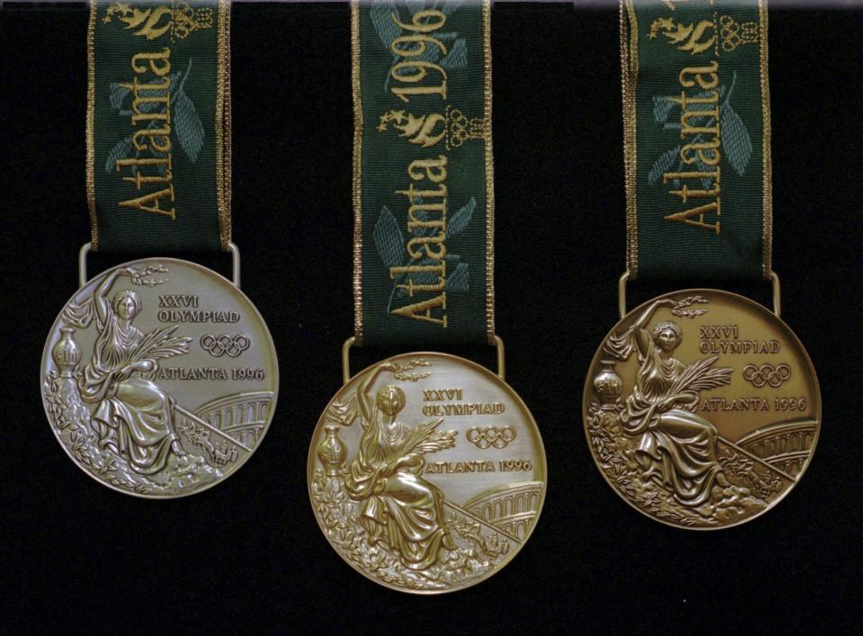 FILE - This is a set of the 1996 Olympic gold, silver, and bronze medals, seen Wednesday, June 12, 1996, in Taunton, Mass., at the Reed & Barton factory. Reed & Barton produced 1,838 medals for the Centennial Olympic games this summer in Atlanta, Ga. (AP Photo/Susan Walsh, File)