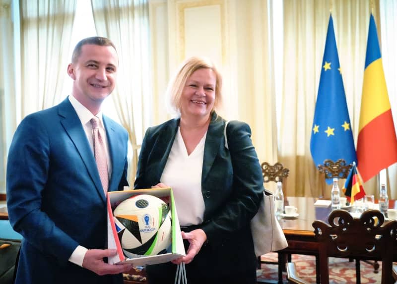 German Minister of the Interior and Home Affairs Nancy Faeser presents Alfred Simonis, President of the Chamber of Deputies of Romania, with a match ball for the European Football Championship 2024 in the parliament building. Soeren Stache/dpa