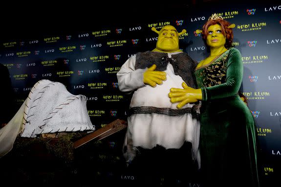 Heidi Klum and Tom Kaulitz dressed as Shrek and Princess Fiona. In the morning, they may or may not be making waffles.
