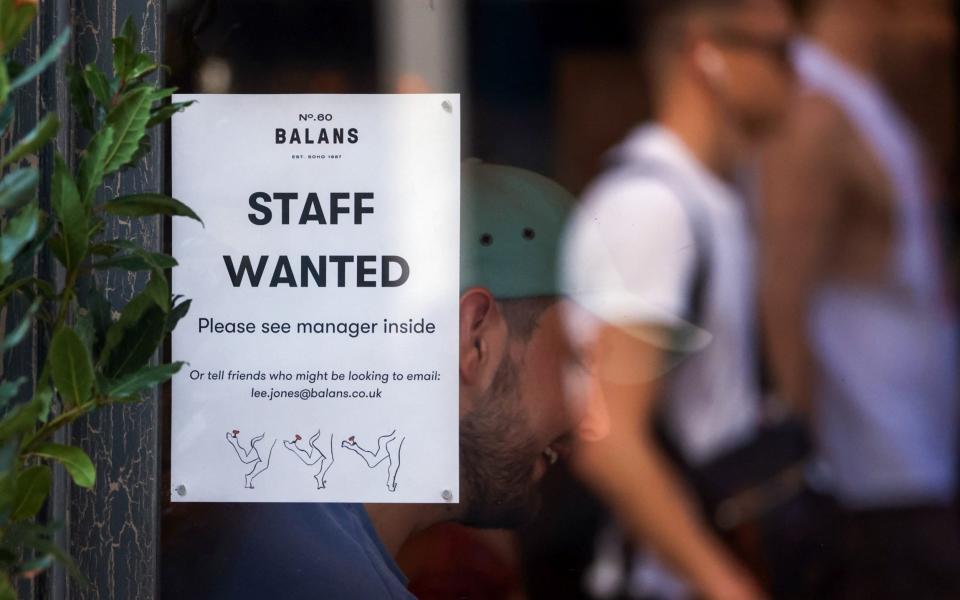 A staff wanted sign in the window of a restaurant in the Soho district of London - Chris Ratcliffe/Bloomberg